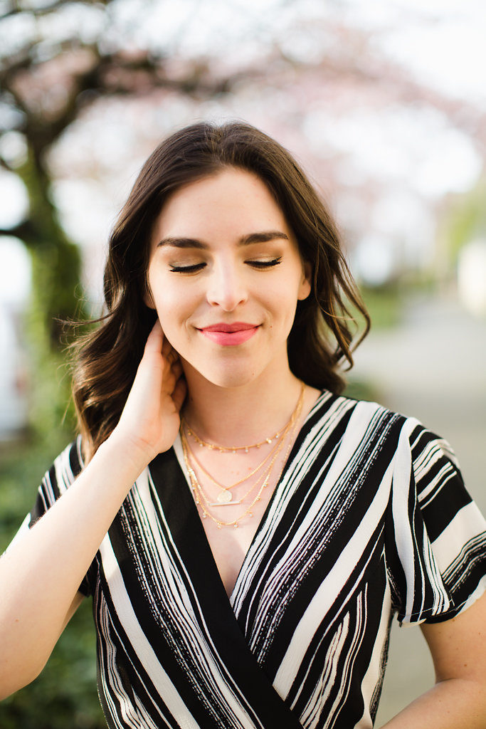 Long layered gold necklaces and Black and white striped maxi dress