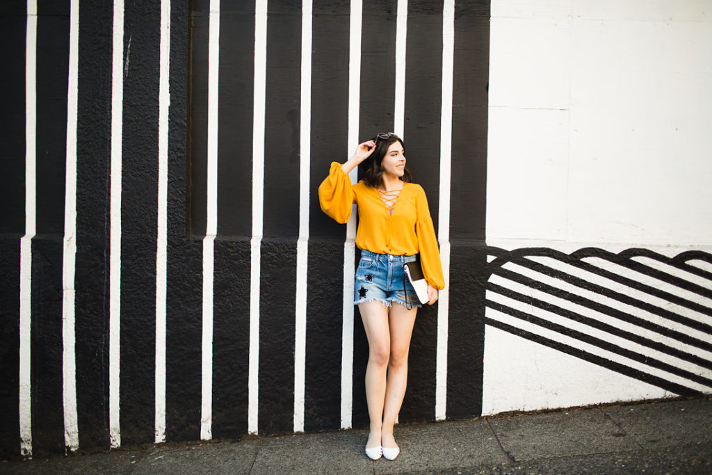Fashion blogger denim shorts and lace up bodysuit
