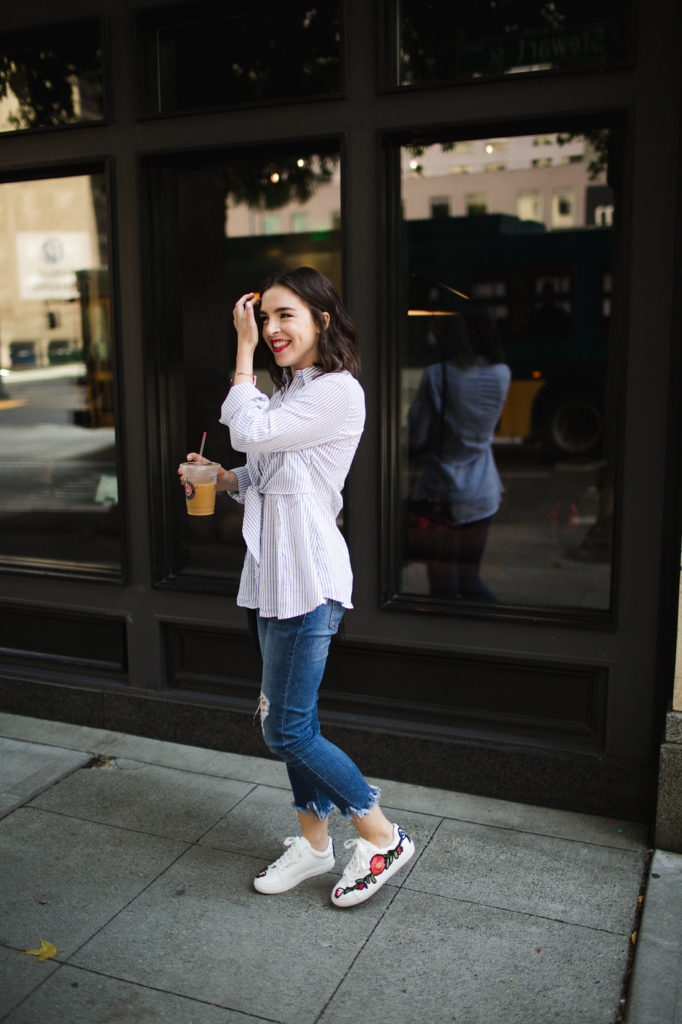 Embroidered white sneakers and distressed denim with frayed hems